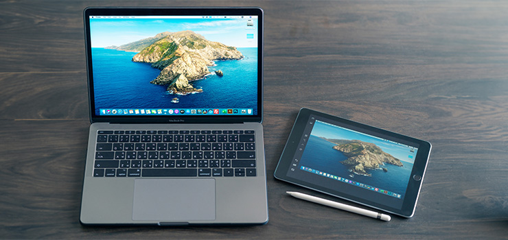 A MacBook and iPad side-by-side, with both screens showing identical images