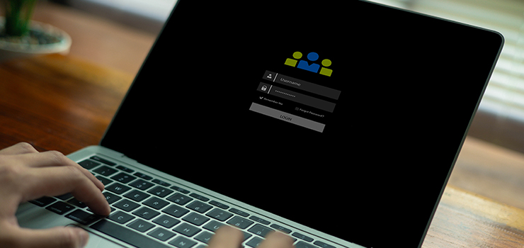 A laptop with a username and password being input