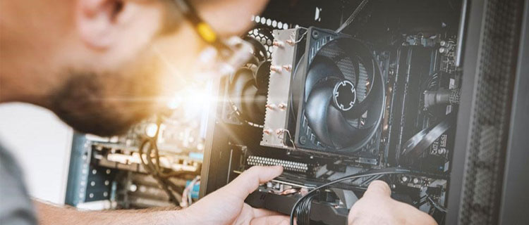 Man wearing safety glasses upgrading the components of a desktop computer