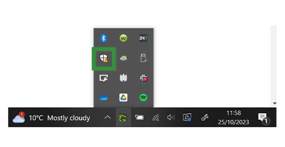 Windows system tray. The Windows Security icon is highlighted.